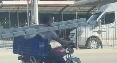 Boynunda merdivenle motosiklet kullandı